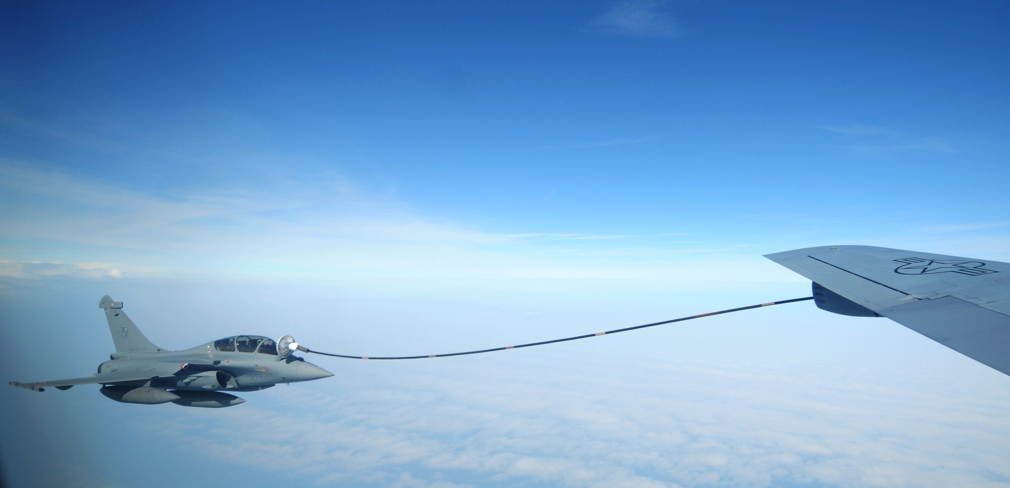 A French air force Rafale takes on fuel from a KC-135 Stratotanker from RAF Mildenhall, England, March 28, 2014, during exercise Tonnerre Lightning. The exercise was a combined endeavor between U.S., British and French air force members to train for real world operations. RAF Mildenhall regularly trains with allied armed forces to help strengthen partnerships and standardize training. (U.S. Air Force photo by Tech. Sgt. Neal Joiner/Released)