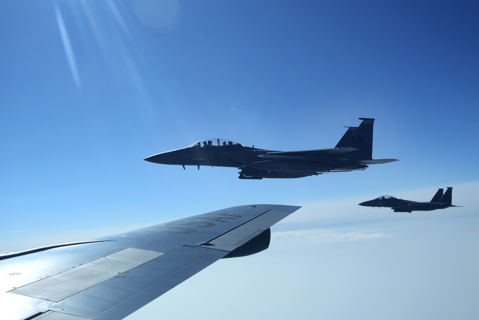 Two F-15E Strike Eagles from RAF Lakenheath, England, fly in formation after taking on fuel from a KC-135 Stratotanker from RAF Mildenhall March 28, 2014, during exercise Tonnerre Lightning. The exercise was a combined endeavor between U.S., British and French air force members to train for real world operations. RAF Mildenhall regularly trains with allied armed forces to help strengthen partnerships and standardize training. (U.S. Air Force photo by Airman 1st Class Dillon Johnston/Released)