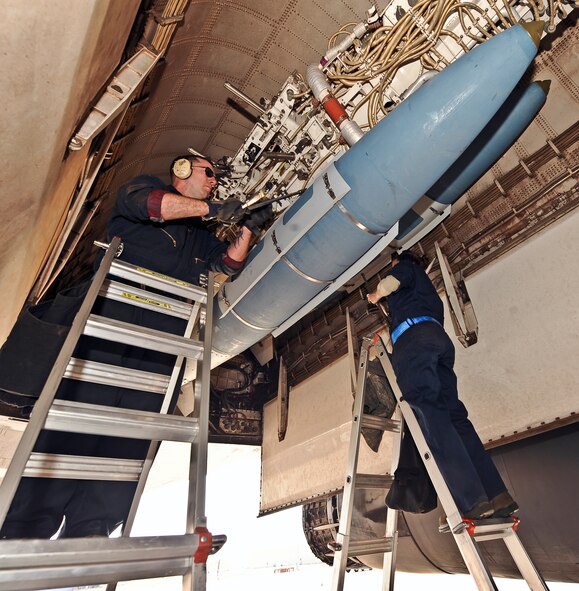 U.S. Air Force Tech Sgt. Charles Winkelspecht, left, and Senior Airman Michelle Doyle, both from the 7th Aircraft Maintenance Squadron, tighten down sway braces on a global positioning system-guided bomb unit in a B-1B Lancer March 25, 2014, at Dyess Air Force Base, Texas. After the bomb is secure in the rack, the sway braces have to be tightened to prevent the bomb from moving in flight. (U.S. Air Force photo by Airman 1st Class Kedesha Pennant/Released)