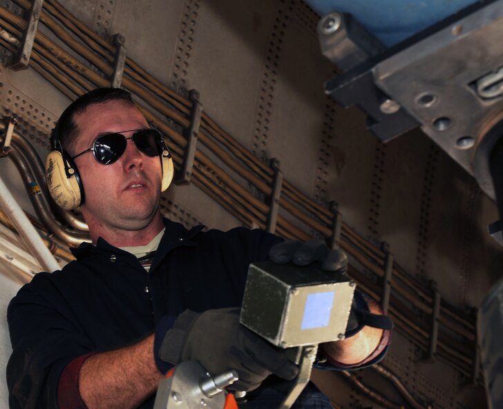 U.S. Air Force Tech Sgt. Charles Winkelspecht, 7th Aircraft Maintenance Squadron, remotely controls a bomb lift truck during a weapons upload March 25, 2014, at Dyess Air Force Base, Texas.  The control unit provides the ability to make the smallest of movements to allow for perfect mating of weapon to aircraft. (U.S. Air Force photo by Airman 1st Class Kedesha Pennant/Released)