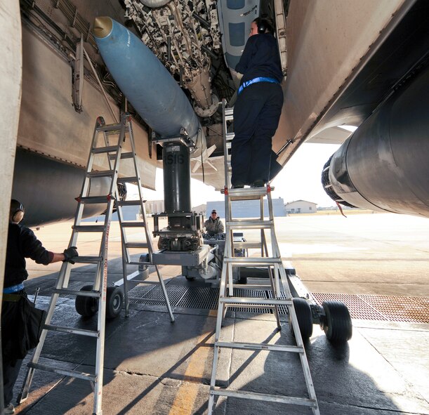 U.S. Air Force Senior Airman Austin Anderson, center, and Senior Airman Michelle Doyle, right, position a general bomb unit onto a B-1B Lancer as Tech Sgt. Charles Winkelspecht, all from the 7th Aircraft Maintenance Squadron, oversees the entire weapons upload March 25, 2014, at Dyess Air Force Base, Texas.  Each task has to be done properly to ensure safety.  (U.S. Air Force photo by Airman 1st Class Kedesha Pennant/Released)