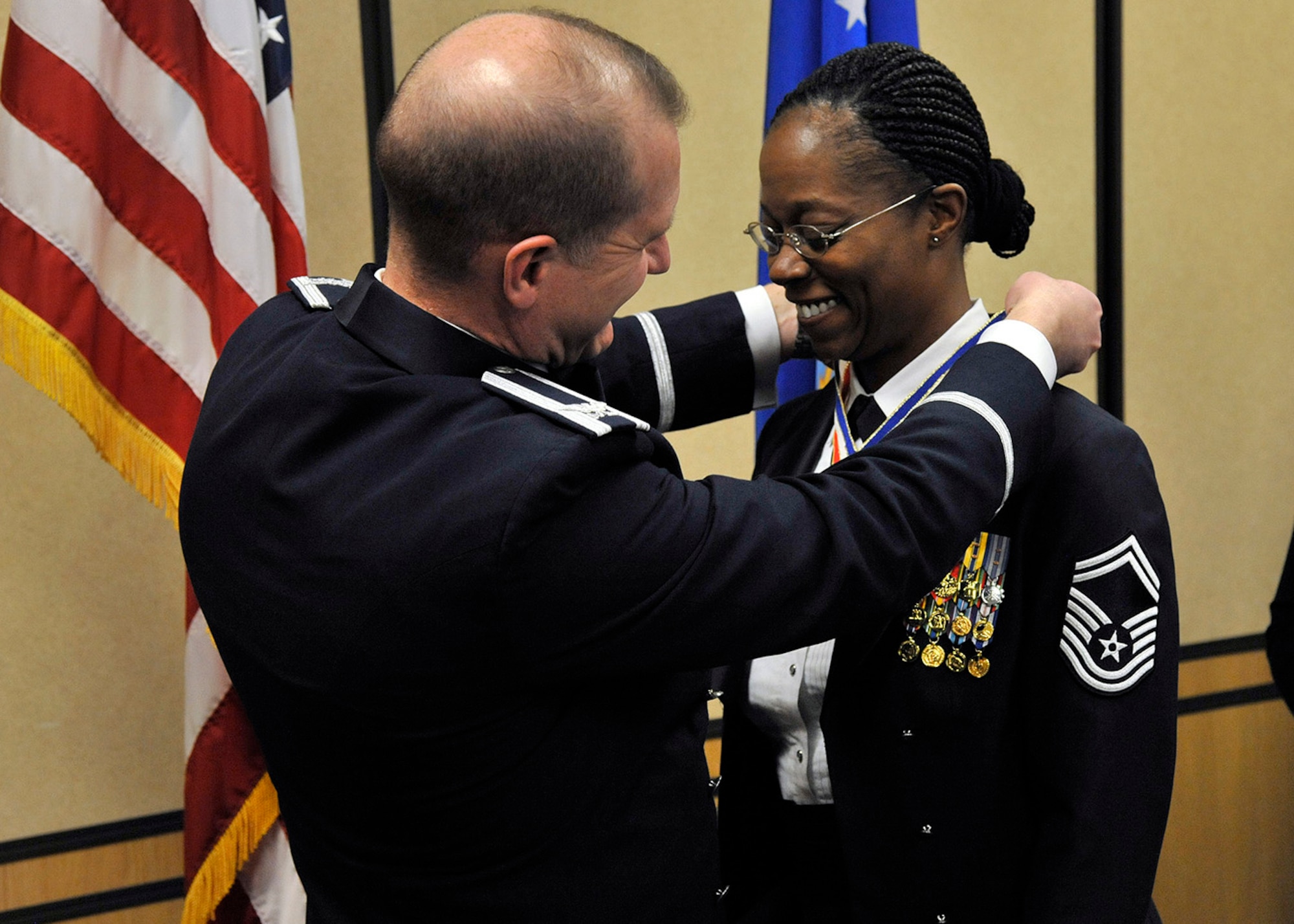 Col. Robert Stanley, 341st Missile Wing commander, puts a medallion on Senior Master Sgt. Nanette Klingaman, 341st Security Forces Squadron superintendent, recognizing her selection to chief master sergeant during a Chief Recognition Banquet at the Grizzly Bend on March 21. The ceremony recognized Klingaman and Senior Master Sgt. Rodney Frotz, 341st Missile Maintenance Squadron superintendent. (U.S. Air Force photo/John Turner)