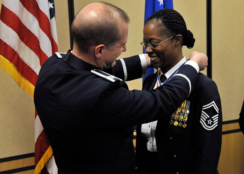 Col. Robert Stanley, 341st Missile Wing commander, puts a medallion on Senior Master Sgt. Nanette Klingaman, 341st Security Forces Squadron superintendent, recognizing her selection to chief master sergeant during a Chief Recognition Banquet at the Grizzly Bend on March 21. The ceremony recognized Klingaman and Senior Master Sgt. Rodney Frotz, 341st Missile Maintenance Squadron superintendent. (U.S. Air Force photo/John Turner)