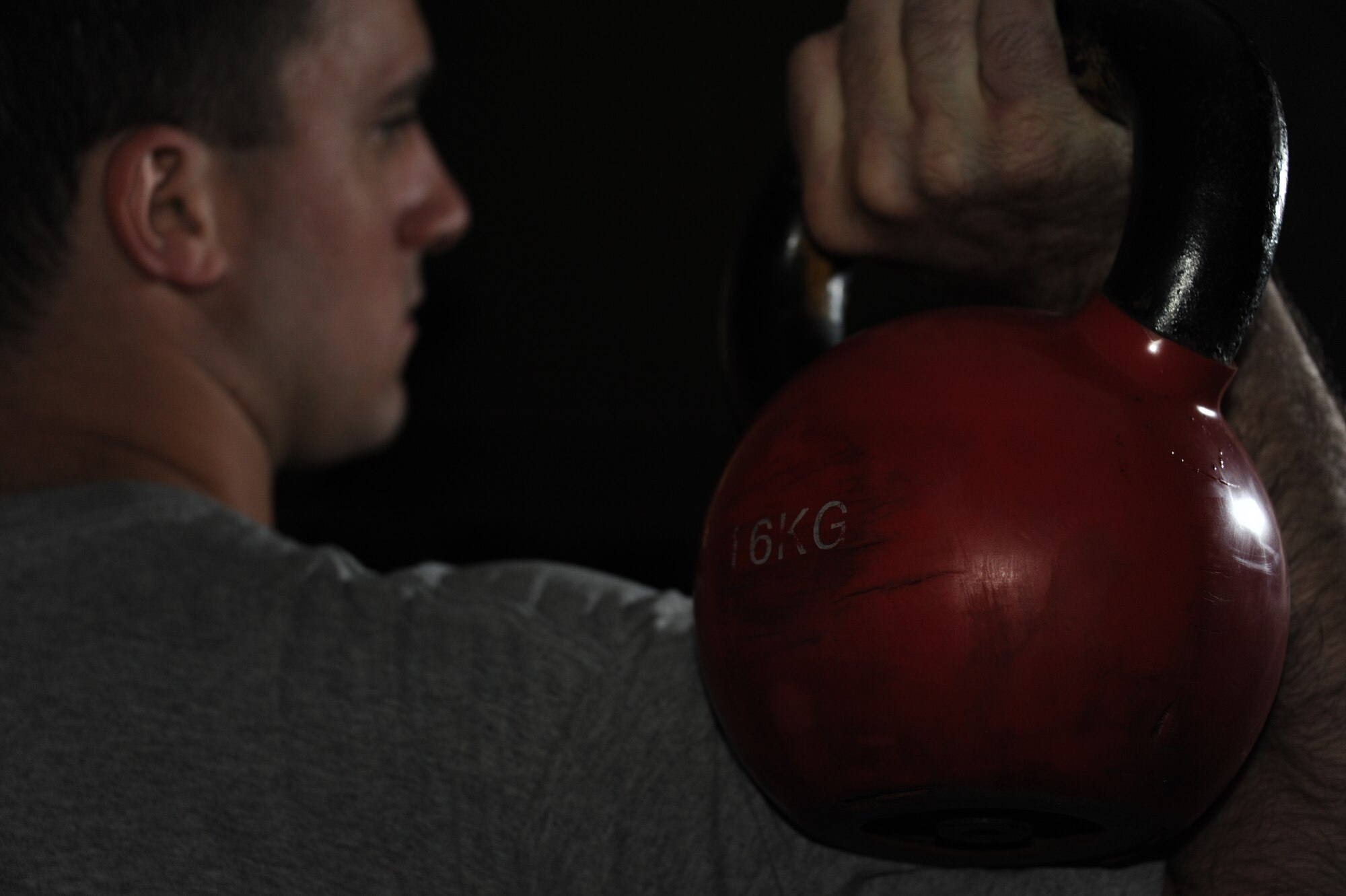 Senior Airman Lance Thornton, Air University programmer, lifts a kettle bell at Maxwell, March 18. Thornton stays fit by lifting weights. (U.S. Air Force photo by Senior Airman William Blankenship) 

