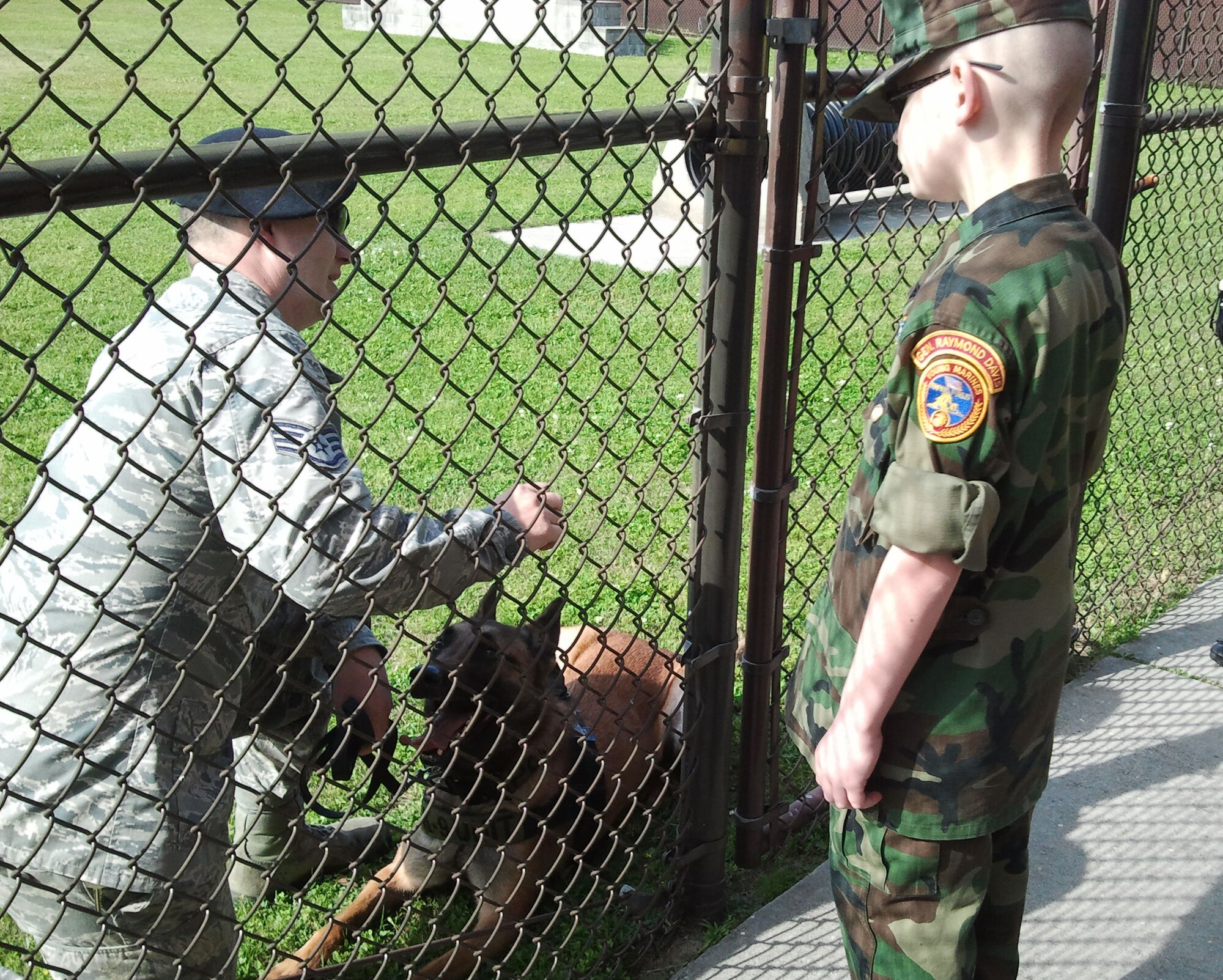 Eleven-year-old Cody Jackson chats with Staff Sgt. Javonnia Peak, 81st 
Security Forces Squadron, and his military working dog, Zeno, after a demonstration at the unit's kennel March 27, 2014, Keesler Air Force Base, Miss.  Jackson, from Alpharetta, Ga., is known as "One Boy USO" for his personal mission to thank as many military members as he can, either by shaking hands, welcoming them home or sending packages to deployed troops.  He was accompanied by his parents and staff members from the local chapter of the American Red Cross. (U.S. Air Force photo by Susan Griggs)
