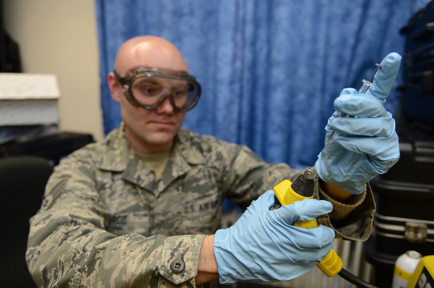 U.S. Air Force Staff Sgt. Jonathan Moroz, 52nd Aerospace Medicine Squadron bioenvironmental technician from Greencastel, Pa., performs a monthly hazardous air pollutant site check at Spangdahlem Air Base, Germany, March 28, 2014. The hazardous air pollutant site check detects volatile organic compounds in the atmosphere. (U.S. Air Force photo by Airman 1st Class Kyle Gese/Released)