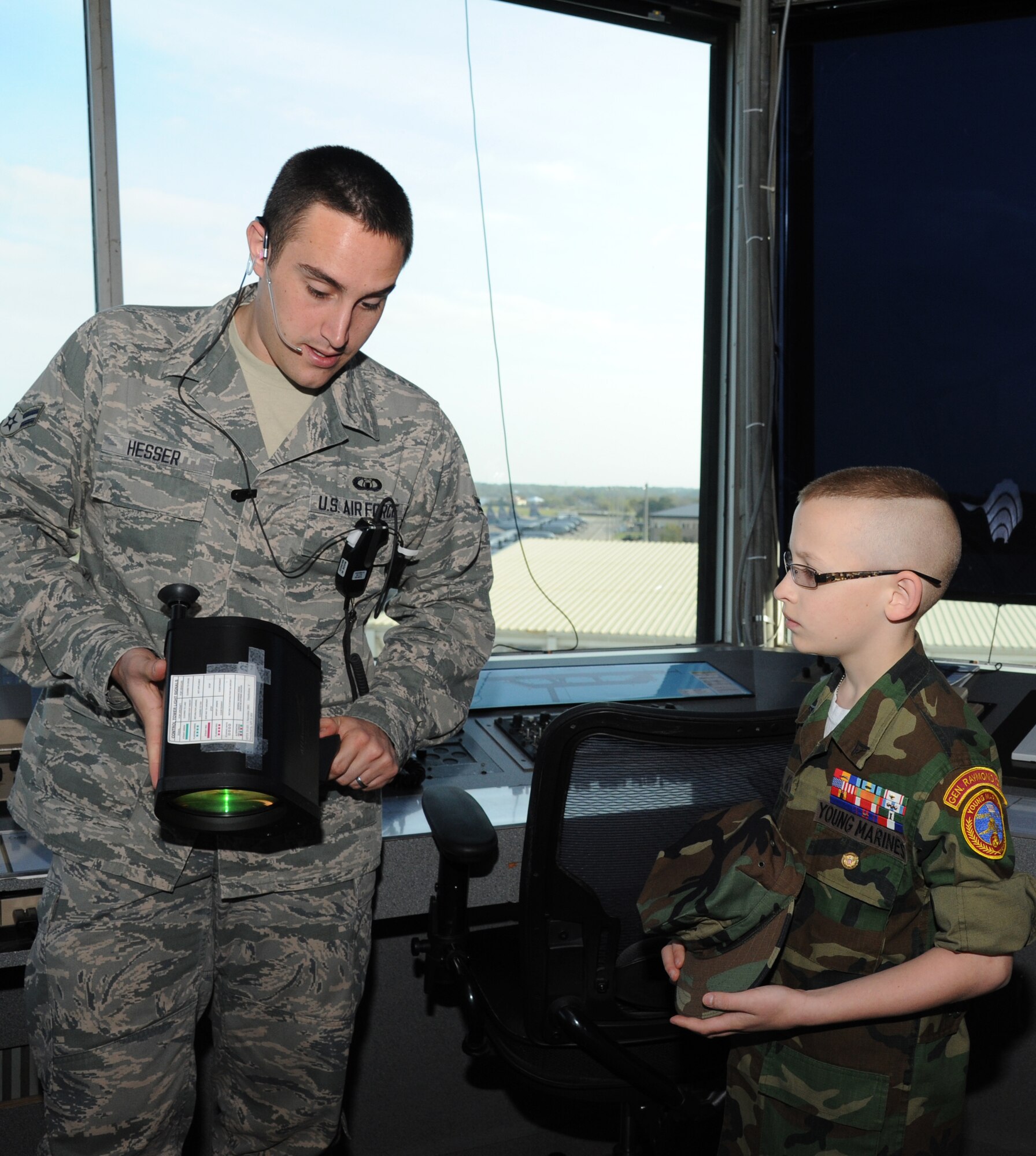 Airman 1st Class Daryle Hesser, 81st Operations Support Flight, shows air traffic control tower equipment to Eleven-year-old Cody Jackson as he receives a tour of the air traffic control tower March 27, 2014, Keesler Air Force Base, Miss.  Jackson, from Alpharetta, Ga., is known as "One Boy USO" for his personal mission to thank as many military members as he can, either by shaking hands, welcoming them home or sending packages to deployed troops.  He was accompanied by his parents and staff members from the local chapter of the American Red Cross. (U.S. Air Force photo by Kemberly Groue)