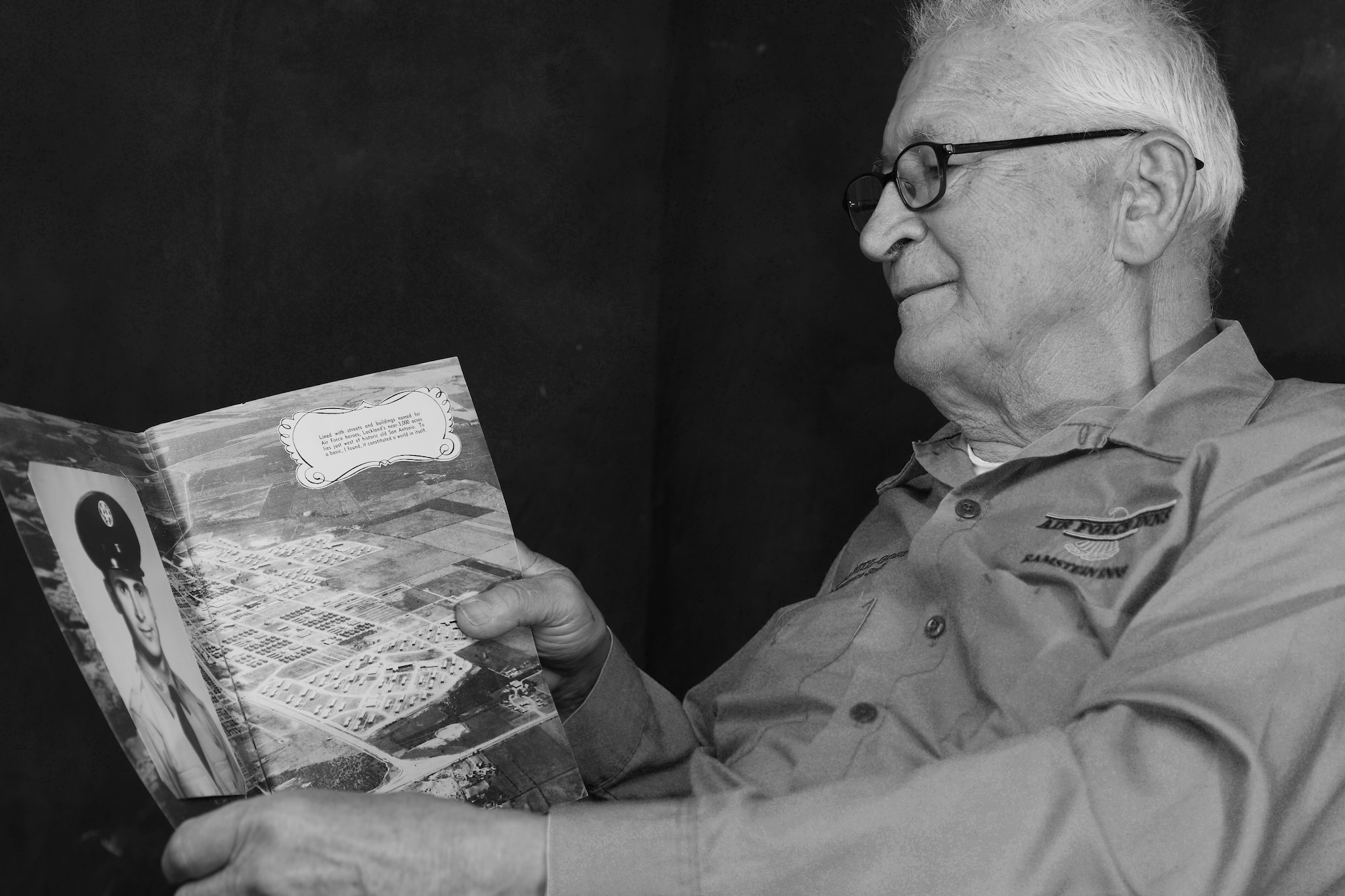 Peter Karpawitz-Godt, Kaiserslautern Military Community clothing issue military management clerk, looks at his Basic Military Training photograph and reminisces about the past March, 18, 2014, at Ramstein Air Base, Germany. Karpawitz-Godt was born and raised in Germany until his father’s friends sponsored him to America to go to school. (U.S. Air Force photo/Airman Dymekre Allen)