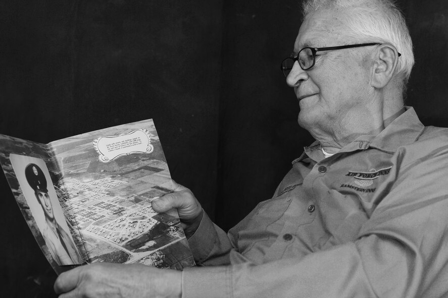 Peter Karpawitz-Godt, Kaiserslautern Military Community clothing issue military management clerk, looks at his Basic Military Training photograph and reminisces about the past March, 18, 2014, at Ramstein Air Base, Germany. Karpawitz-Godt was born and raised in Germany until his father’s friends sponsored him to America to go to school. (U.S. Air Force photo/Airman Dymekre Allen)