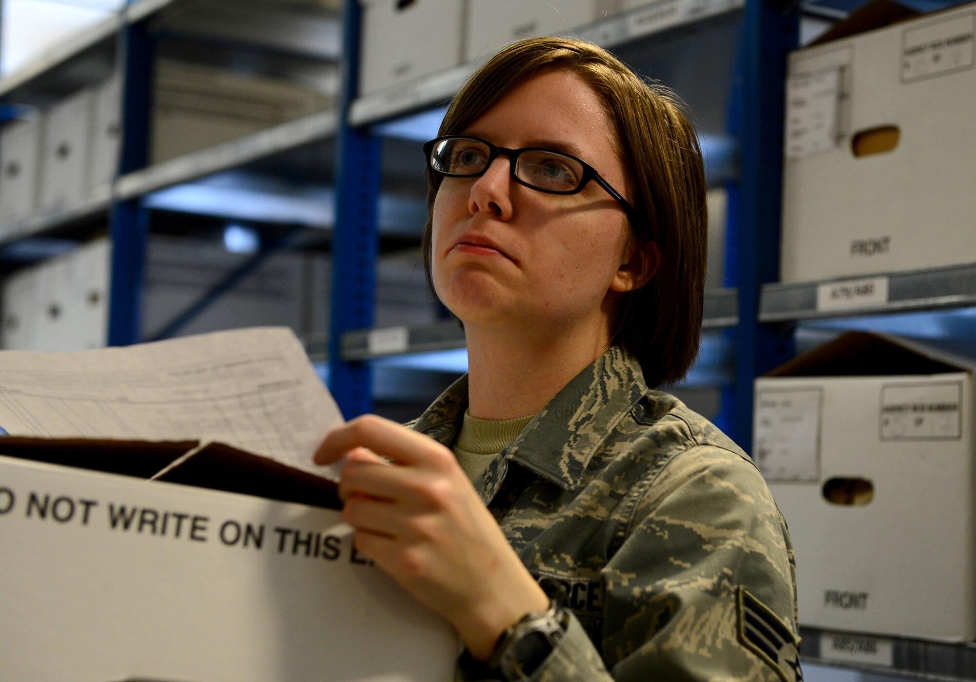 Airman 1st Class Ashley Janicki, 48th Communications Squadron knowledge operator, files a standard-form 135 at Royal Air Force Lakenheath, England, March 28, 2014. Janicki was nominated for a Liberty Spotlight because she displays the core value of ‘Service Before Self.’ (U.S. Air Force photo by Airman 1st Class Dawn M. Weber/Released)  