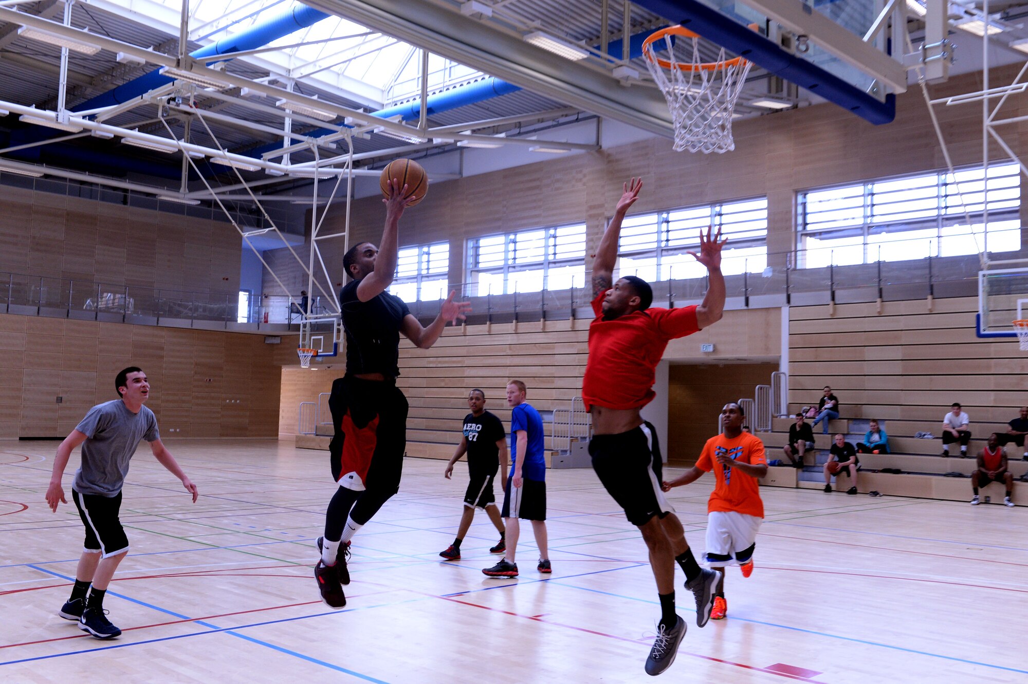 Airman 1st Class Phillip Jackson, 52nd Civil Engineer Squadron water, fuels system maintenance apprentice, from Folkston, Georgia, shoots during a First IV-sponsored March Madness basketball tournament at the Eifel Powerhaus at Spangdahlem Air Base, Germany, March 27, 2014. The event was free and the winning team took home gift certificates for The Exchange given by the Spangdahlem Top 3. (U.S. Air Force photo by Senior Airman Alexis Siekert/Released)