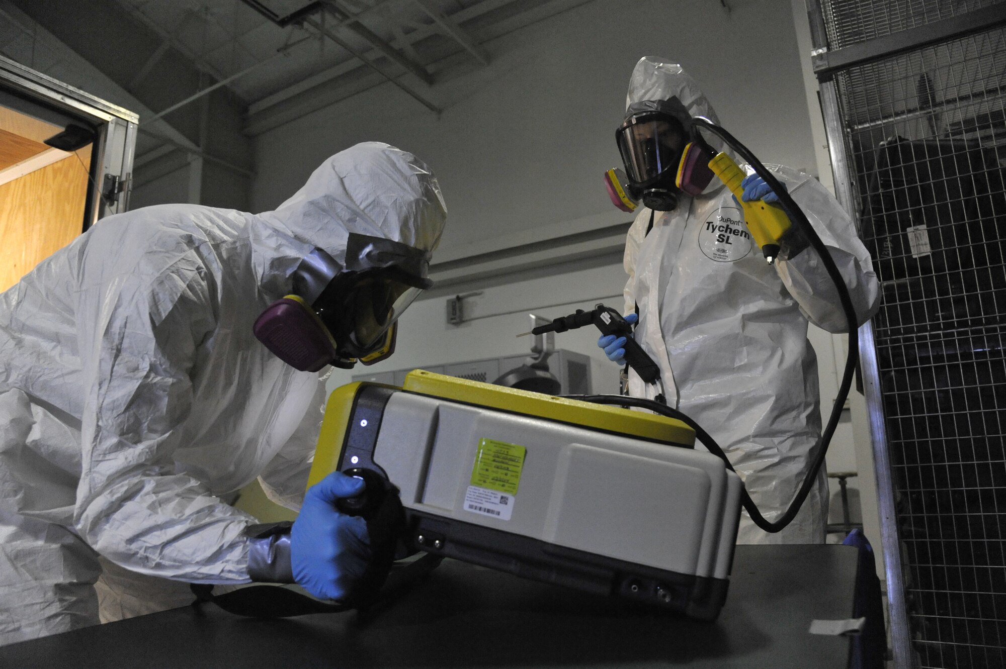 Staff Sgt. Tyler Haugland, 509th Medical Operations Squadron bioenvironmental readiness and radiation program manager, left, and Tech. Sgt. Annemieke LeBorgne, 509th Medical Operations Squadron NCO in charge of Occupational Health, prepares the HAPSITE at Whiteman Air Force Base, Mo. March 12, 2014. The HAPSITE is used to identify and quantify potential unknowns.. (U.S. Air Force photo by Airman 1st Class Keenan Berry/Released)