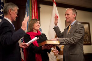 Secretary of the Army John McHugh administers the oath of office to Brad R. Carson to be the 31st Under Secretary of the Army, as his wife, Julie, holds the Bible, during a ceremony at the Pentagon, March 27, 2014. Carson previously served as the Army's 20th General Counsel, a position held since 2012. (U.S. Army photo by Staff Sgt. Bernardo E. Fuller/Released)