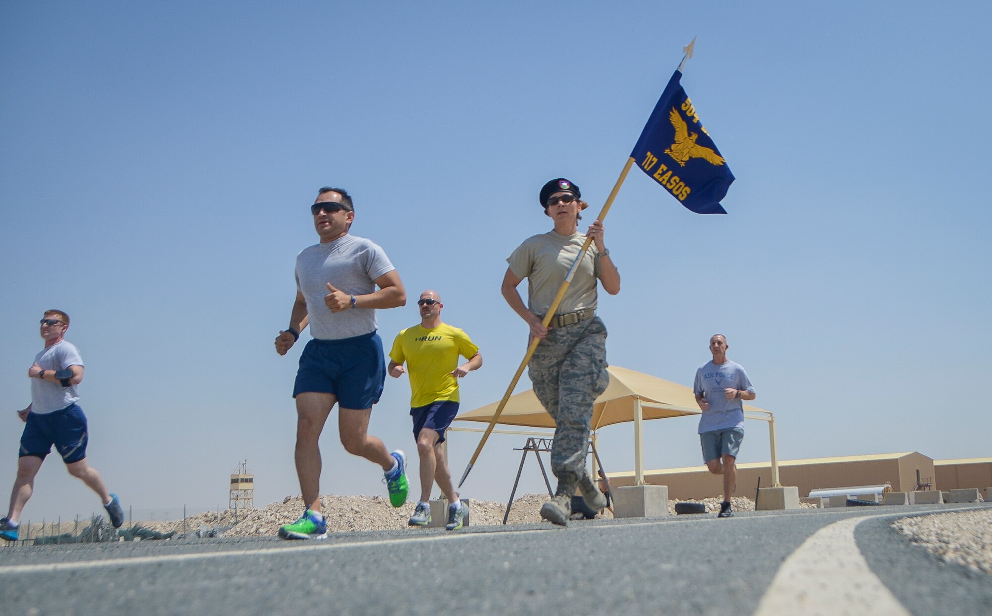 Service members run around a track during a 24-hour Tactical Air Control Party remembrance run at Al Udeid Air Base, Qatar, March 27, 2014. The event was held to ensure those warriors who have made the ultimate sacrifice are never forgotten. This year’s 24-hour TACP challenge was the third annual event dedicated to the 10 fallen TACP warriors who were killed in combat and training operations within the last 20 years. The event was held world-wide with every TACP unit starting the run March 27 at noon local time. (U.S. Air Force photo/Senior Airman Jared Trimarchi) 