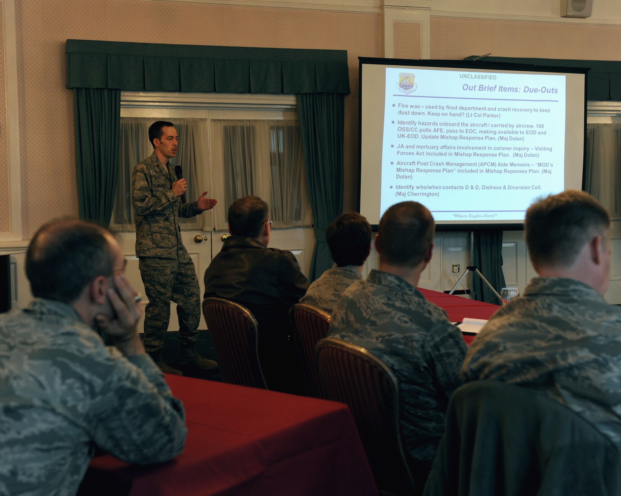 U.S. Air Force Maj. Douglas Murphy, 100th Air Refueling Wing Plans and Programs chief, presents the results from the tabletop exercise March 25, 2014, in Middleton Hall on RAF Mildenhall, England. The exercise revealed potential difficulties for real-world emergencies. Exercises prepare U.S. Air Force units, members of the RAF and local nationals to better communicate with one another to overcome possible complications. (U.S. Air Force photo by Airman 1st Class Preston Webb/Released)