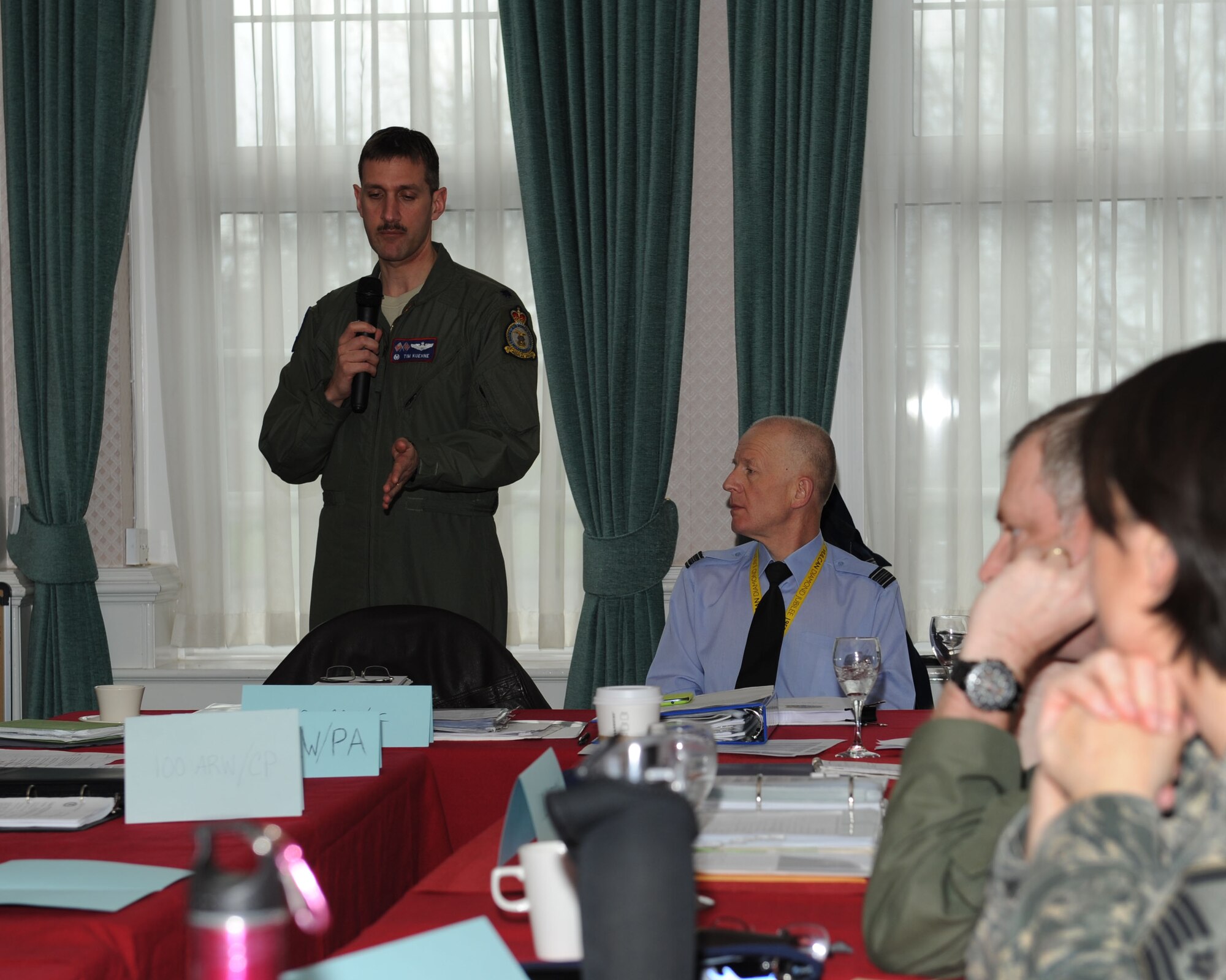 U.S. Air Force Lt. Col. Timothy Kuehne, 351st Air Refueling Squadron commander, speaks to Team Mildenhall members March 25, 2014, during a tabletop exercise in Middleton Hall on RAF Mildenhall, England. Kuehne filled the role of wing commander during the exercise. One of the difficulties Kuehne pointed out about the exercise was coordinating quickly enough to reach expected deadlines for public release of information about the “incident.” (U.S. Air Force photo by Airman 1st Class Preston Webb/Released)
