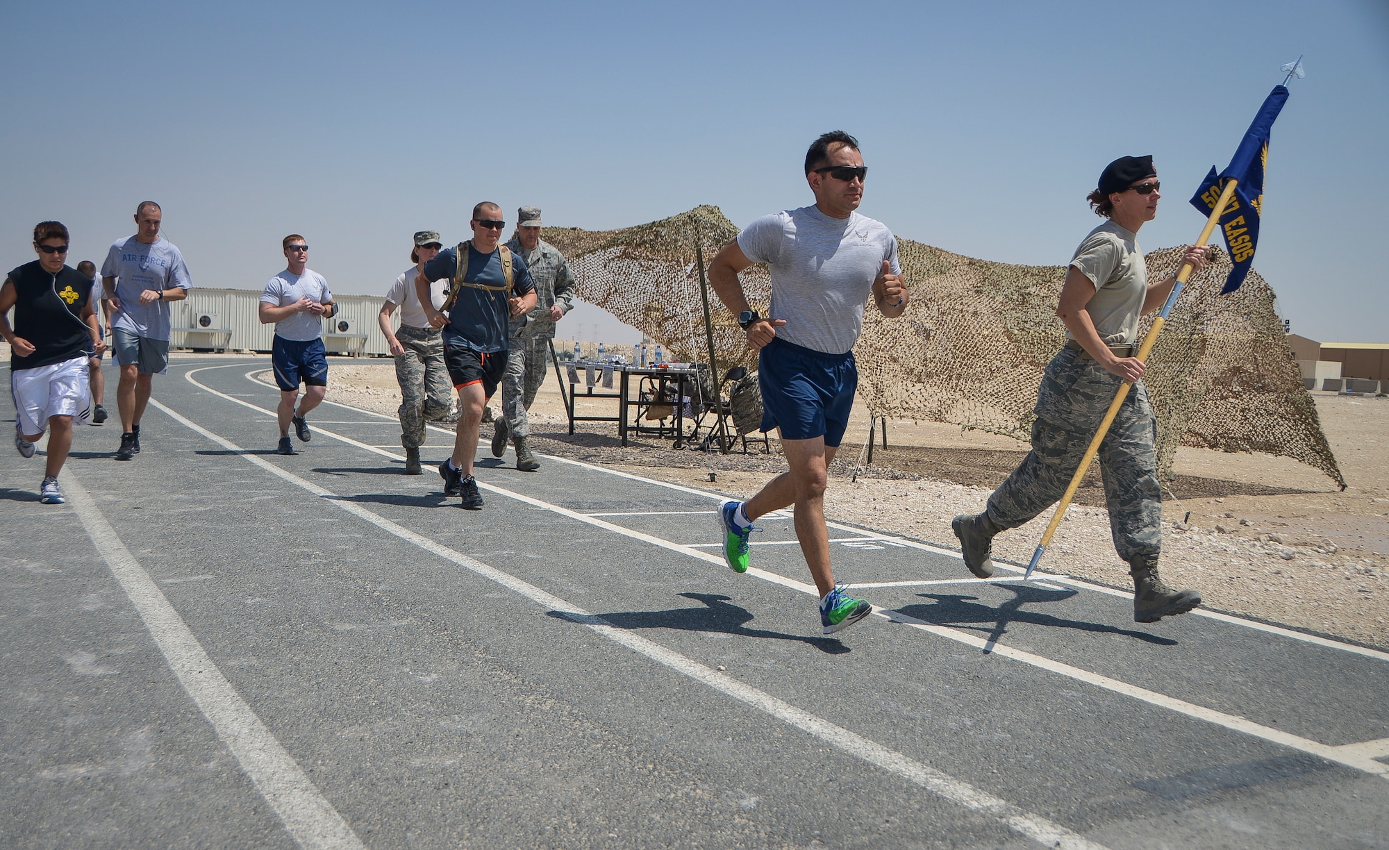 Service members kick off a 24-hour Tactical Air Control Party remembrance run at Al Udeid Air Base, Qatar, March 27, 2014. The event was held to ensure those warriors who have made the ultimate sacrifice are never forgotten. This year’s 24-hour TACP challenge was the third annual event dedicated to the 10 fallen TACP warriors who were killed in combat and training operations within the last 20 years. The event was held world-wide with every TACP unit starting the run March 27 at noon local time. (U.S. Air Force photo/Senior Airman Jared Trimarchi) 