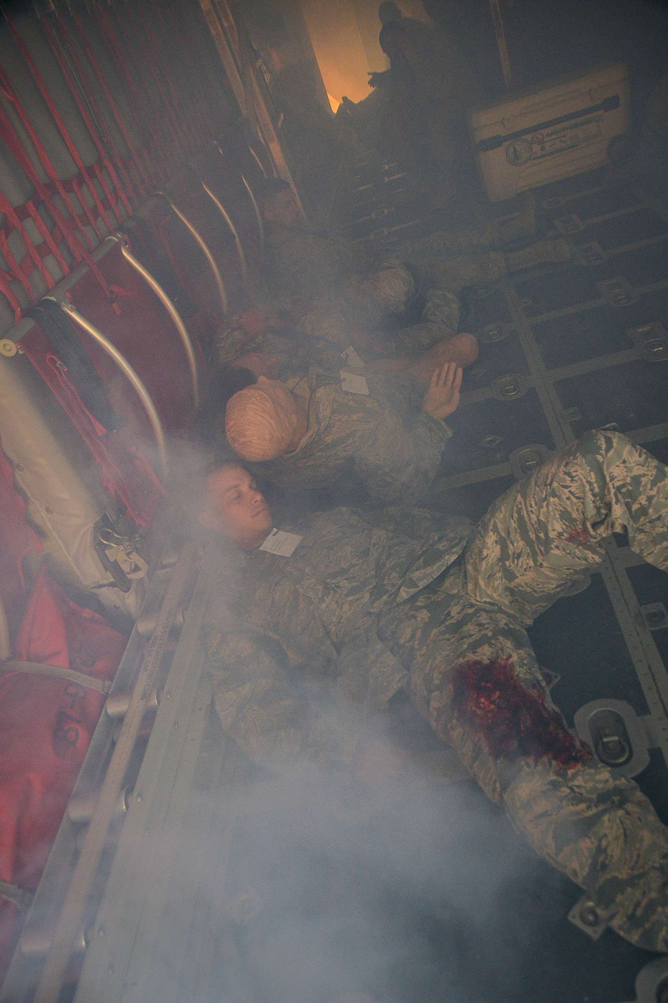 Simulated patients wait for emergency response personnel aboard a C-130 Hercules during a base-wide Major Accident Response Exercise at Al Udeid Air Base, Qatar, March 21, 2014. The simulated scenario for the MARE involved a crash at the end of a runway with 20 service members onboard. Organizations from all over the base including host nation counterparts had to react to the exercise as if it were the real deal. (U.S. Air Force photo/Senior Airman Jared Trimarchi) 