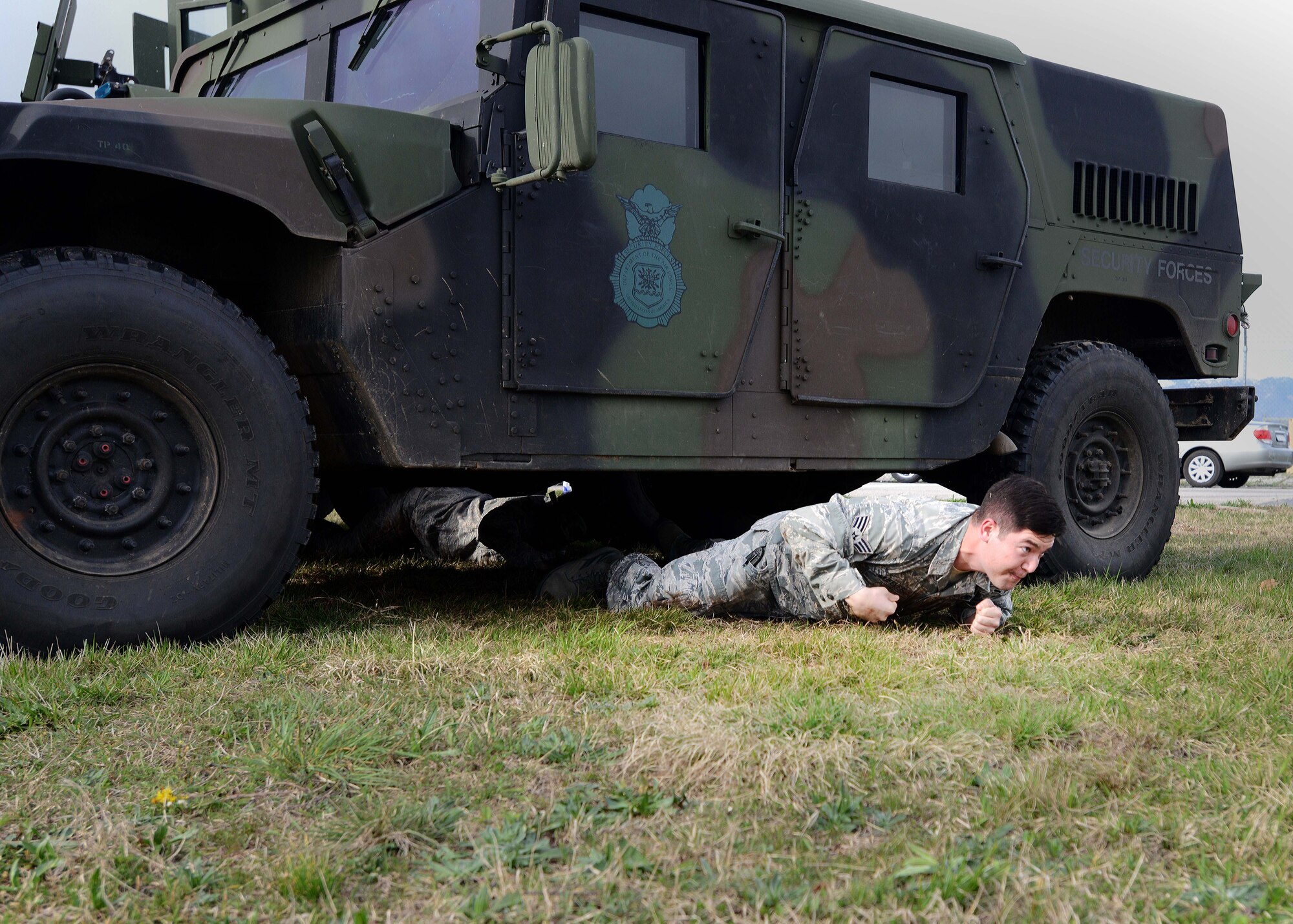 Senior Airman Kevin Wheeler, Aviano Airman Leadership School student, low crawls during a combat challenge. Students from ALS Class 14-C participated in strenuous physical fitness challenges while being encouraged from class mates and various first sergeants around the base. (U.S. Air Force photo/Airman 1st Class Deana Heitzman)  