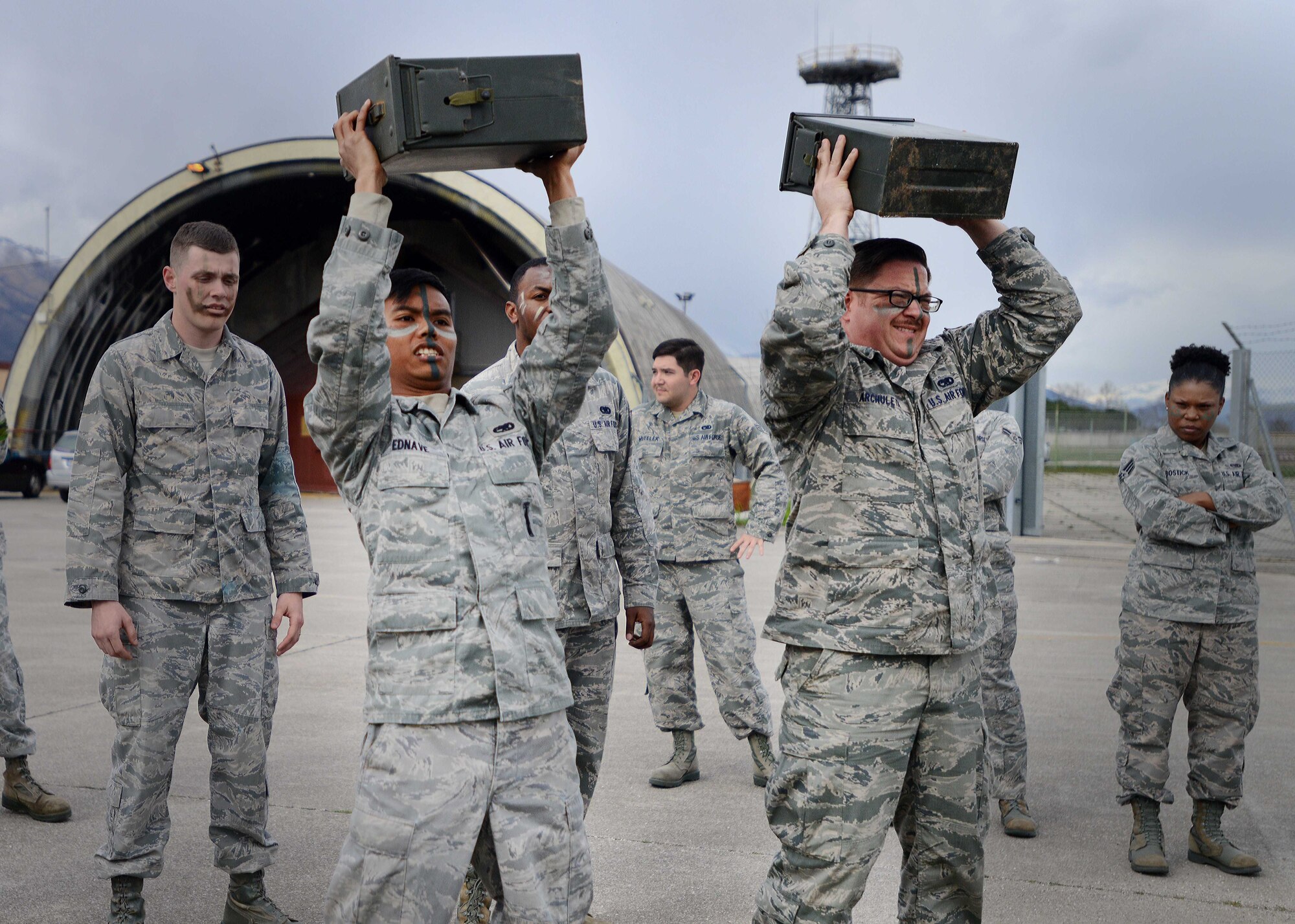 (From Left) Senior Airman Bryan Ednave and Joseph Archuleta, Aviano Airman Leadership School students, lift ammo boxes during a combat challenge, March 24, 2014, at Aviano Air Base, Italy.  Students competed against each other to complete the challenge by doing push-ups, low crawls, sit ups and buddy drags. (U.S. Air Force photo/Airman 1st Class Deana Heitzman)