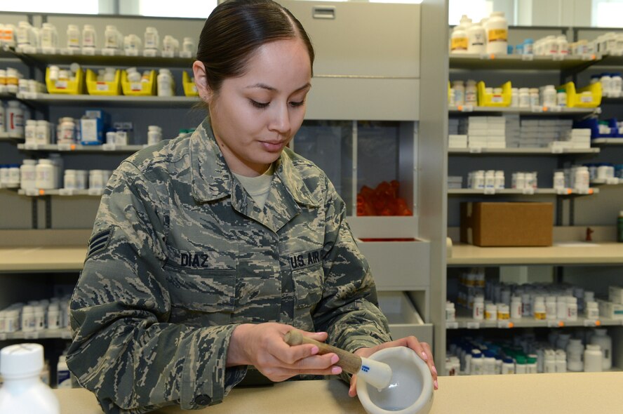 U.S. Air Force Senior Airman Venessa Diaz, 52nd Medical Support Squadron pharmacy technician from Dilley, Texas, mixes a medication at Spangdahlem Air Base, Germany, March 25, 2014. A mortar and pestle is used to crush or grind a substance into a powder and is a common practice for compounding. The pharmacy fills approximately 200 prescriptions per day and offers counseling advice for patients with questions about pharmaceuticals. (U.S. Air Force photo by Airman 1st Class Kyle Gese/Released)