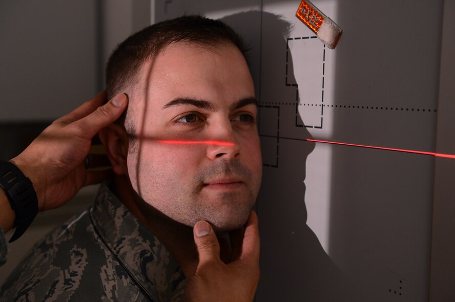 U.S. Air Force Tech Sgt. David Luce, 52nd Medical Support Squadron diagnostic imaging NCO in charge from Vacaville, Calif., positions his head for a cranium X-ray at Spangdahlem Air Base, Germany, March 25, 2014. X-rays not only can be used to identify broken bones, but also help diagnose disease and help plan treatment. In a radiographic image, lungs filled with air appear as black, fatty tissues appear as different shades of gray and bones appear whiter. (U.S. Air Force photo by Airman 1st Class Kyle Gese/Released) 