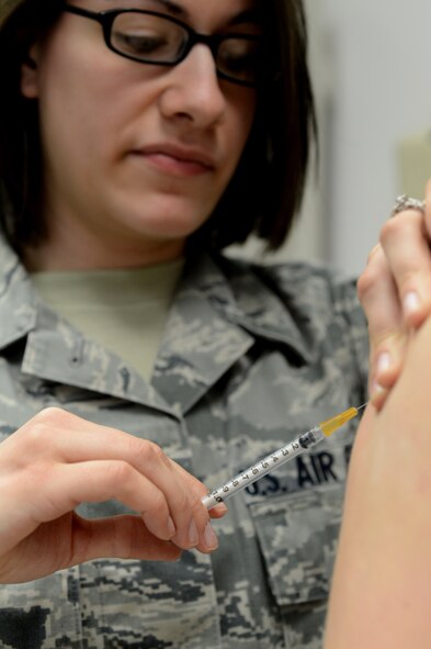 U.S. Air Force Senior Airman Jaryl Burjoss, 52nd Medical Operations Squadron allergy immunology technician from Morresville, N.C., administers a vaccine to a patient at Spangdahlem Air Base, Germany, March 25, 2014. Vaccines are used to improve the immune system which prevents sickness or diseases from infecting the body. (U.S. Air Force photo by Airman 1st Class Kyle Gese/Released)