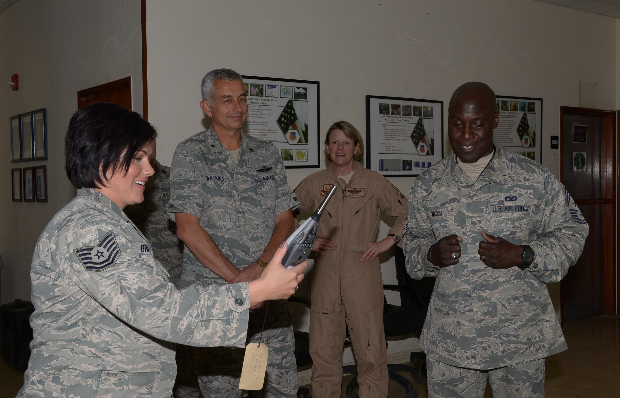 Tech. Sgt. Tawsha Bricker briefs 379th Air Expeditionary Wing senior leaders on a sound level meter at Al Udeid Air Base, Qatar, Mar. 25, 2014. The sound level meter is used to instantly read noise levels which are used to evaluate hazardous noise. Bricker is the 379th Expeditionary Medical Operation Squadron bioenvironmental element NCO in charge, deployed from Ellsworth Air Force Base, S.D., and a Helena, Mont., native. (U.S. Air Force photo/Senior Airman Hannah Landeros)