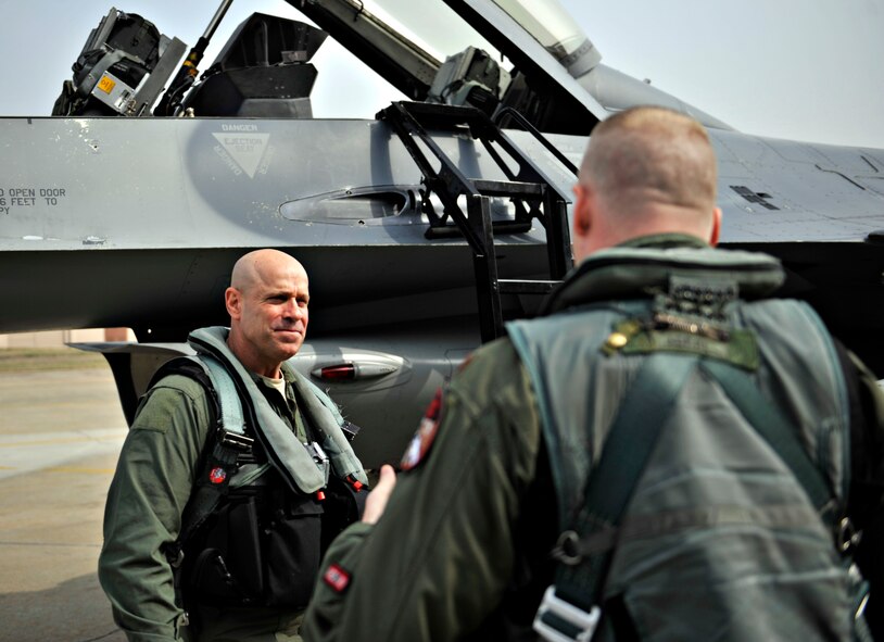 U.S. Army Command Sgt. Maj. Ray Devens, 8th Army command sergeant major, listens to final words of advice before his familiarization flight at Osan Air Base, Republic of Korea, March 28, 2014. A familiarization flight is different from an incentive flight in that a fam flight is a routine training exercise that can include an extra passenger. (U.S. Air Force photo/Senior Airman Siuta B. Ika)