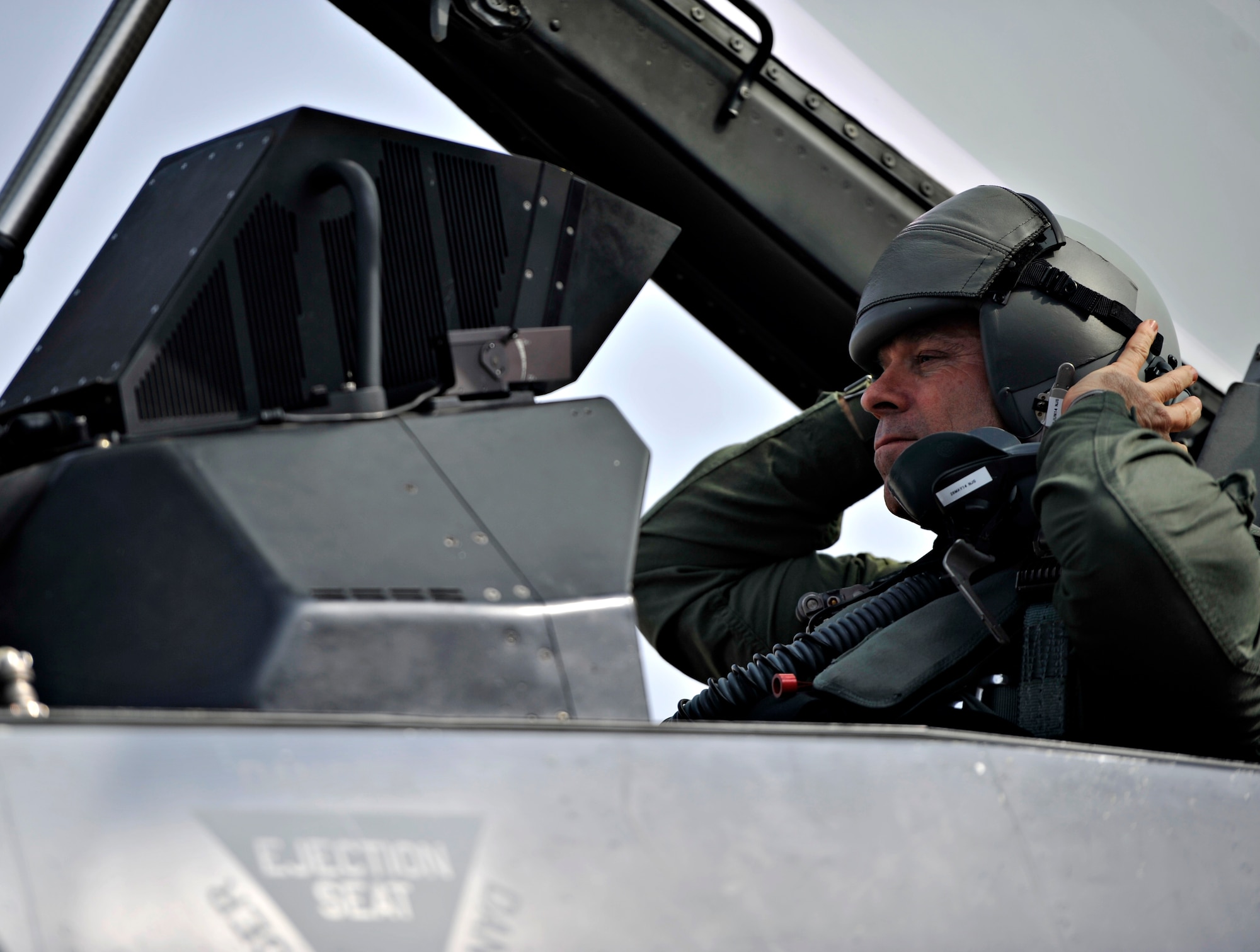 U.S. Army Command Sgt. Maj. Ray Devens, 8th Army command sergeant major, puts on his helmet before his familiarization flight at Osan Air Base, Republic of Korea, March 28, 2014. Devens, who has participated in several combat operations, was permitted to ride along in an F-16 Fighting Falcon to experience the aircraft’s capabilities and to better understand the mission of the 36th Fighter Squadron. (U.S. Air Force photo/Senior Airman Siuta B. Ika)