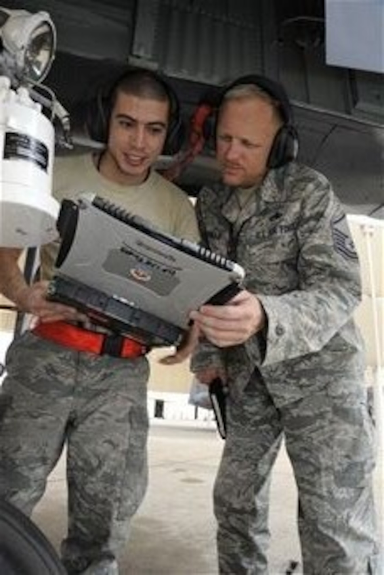 U.S. Air Force Senior Airman Arrec Chetwood, 355th Aircraft Maintenance Squadron A-10 crew chief, explains instructions on a technical order to Master Sgt. Stephen Murray, Air Combat Command Inspector General inspector, at Davis-Monthan Air Force Base, Ariz., March 25, 2014.The 355th Fighter Wing received a capstone for a unit effectiveness inspection, a new inspection that was implemented in August 2013 to combine consolidated unit inspections and operational readiness inspections into one continuous inspection. (U.S. Air Force photo by Airman 1st Class Betty R. Chevalier/released)
