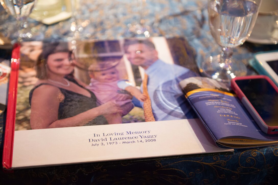 A book cover with a photograph honors the memory of David Laurence Yaggy, a Marine Corps major who died March 14, 2008, while serving as a flight instructor on a training mission, during the 2014 Tragedy Assistance Program for Survivors Honor Guard Gala at the National Building Museum in Washington, D.C., March 27, 2014.