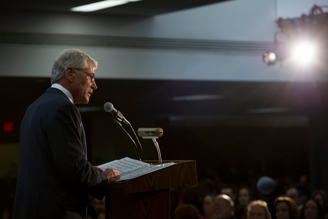 Defense Secretary Chuck Hagel delivers remarks at the retirement ceremony of Army Gen. Keith Alexander, who is stepping down as head of U.S. Cyber Command and the National Security Agency, at the agency's headquarters on Fort George Meade, Md., March 28, 2014.