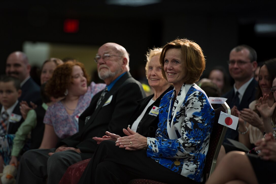 Deborah Alexander, wife of Army Gen. Keith Alexander, who is stepping down as head of U.S. Cyber Command and the National Security Agency, holds back tears during Alexander's retirement ceremony at the agency's headquarters on Fort George Meade, Md., March 28, 2014.