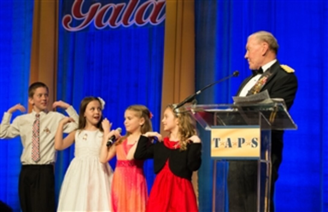 Army Gen. Martin E. Dempsey, chairman of the Joint Chiefs of Staff, talks with children on stage during the 2014 Tragedy Assistance Program for Survivors Honor Guard Gala at the National Building Museum in Washington, D.C., March 27, 2014. The program, known as TAPS, is a 24-hour resource for anyone who has suffered the loss of a military loved one, regardless of the relationship to the deceased or the circumstance of the death.