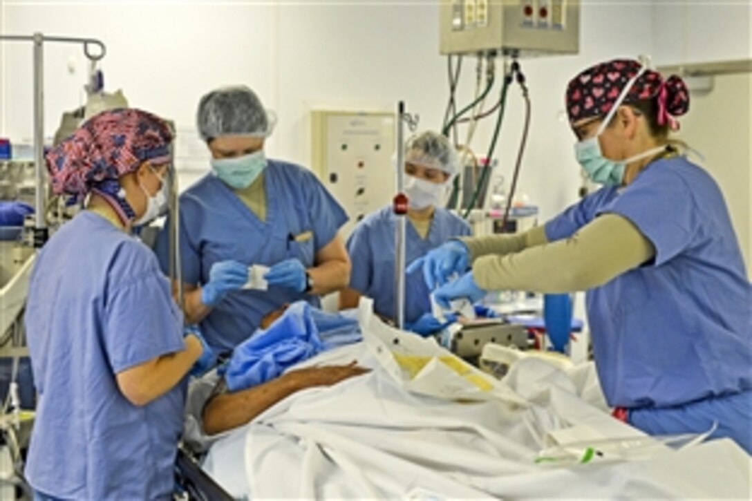 U.S. Air Force 1st Lt. Christina Chuchuru, U.S. Air Force Capt. Teresa Sellers, U.S. Army Sgt. Mary Shannon McCay and U.S. Air Force Lt. Col. Allison Cogar prepare a patient for surgery at Craig Joint Theater Hospital on Bagram Airfield, Afghanistan, March 18, 2014. Chuchuru, Sellers, McCay and Cogar work together in the operating room.