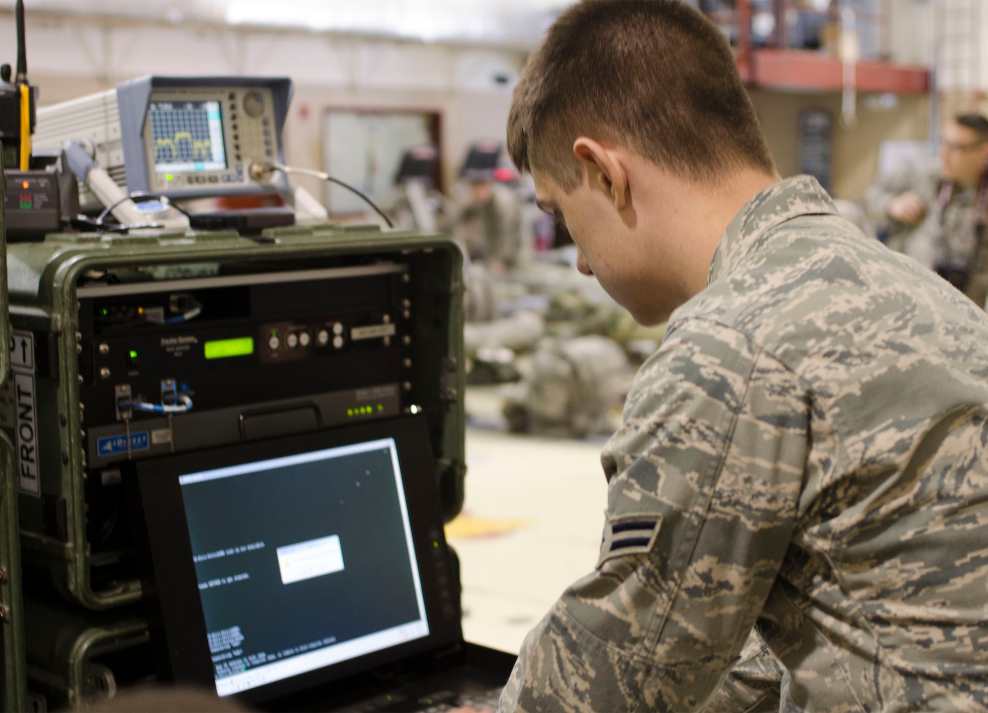 U.S. Air Force Airman 1st Class Christian J. Deguire, an information technology specialist with the 128th Air Control Squadron, out of Volk Field, Wis., sets up communication with the Joint Incident Site Communication Capability system during exercise Alaska Shield 14, March 28, 2014. Alaska Shield 14 is an exercise that involves state, federal, military, andlocal agencies, designed to test the response and coordination of the a disaster modeled after the 1964 earthquake and subsequent tsunami that devastated much of South Central Alaska including the city of Valdez. (U.S. Army photo by Spc. True Thao)
