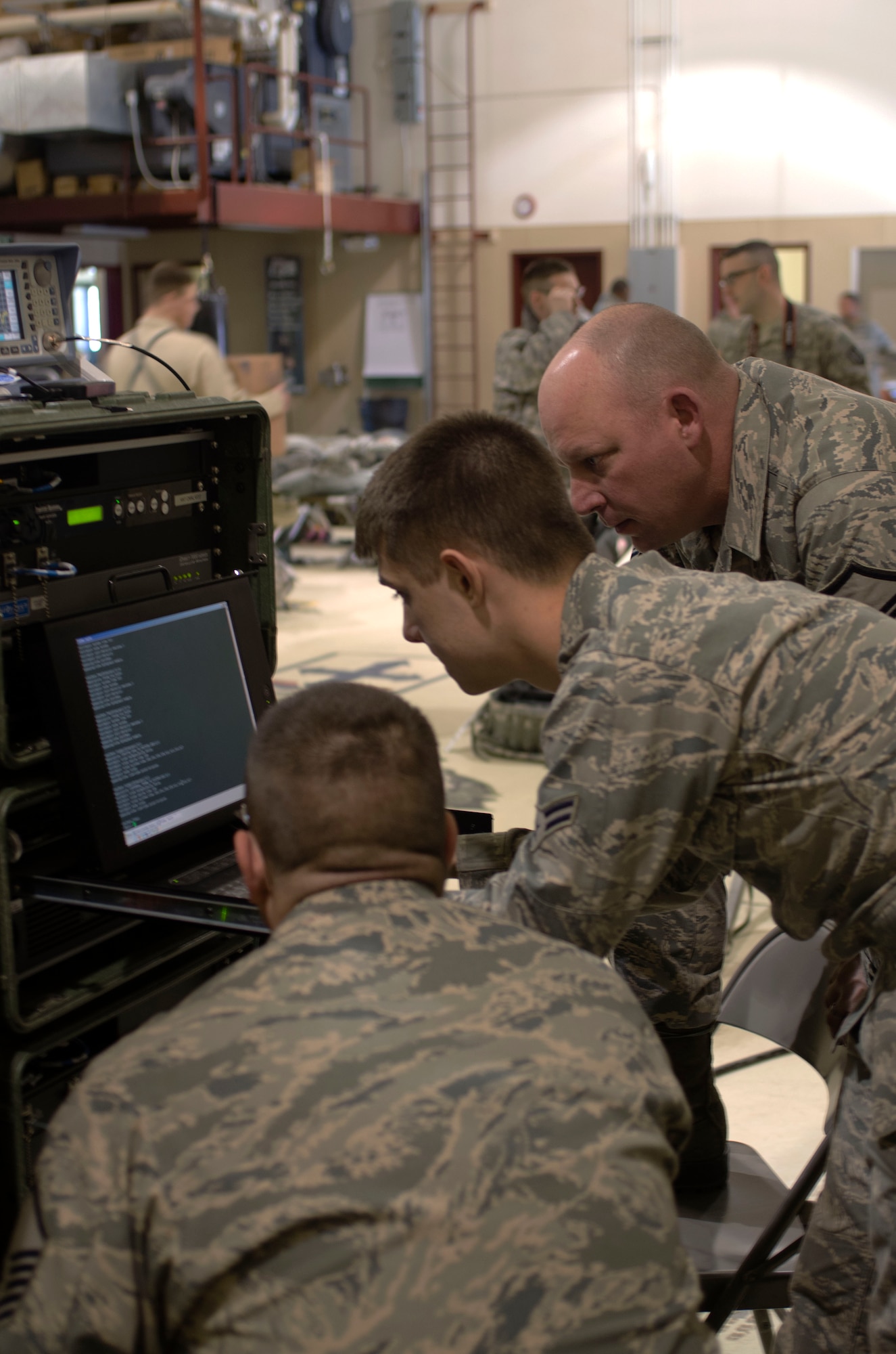 U.S. Air Force airmen with the 128th Air Control Squadron out of Volk Field, Wis., work together to set up communication with the Joint Incident Site Communication Capability system during exercise Alaska Shield 14, March 28, 2014.Alaska Shield 14  is an exercise that involves state, federal, military, andlocal agencies, designed to test the response and coordination of the a disaster modeled after the 1964 earthquake and subsequent tsunami that devastated much of South Central Alaska including the city of Valdez.. (U.S. Army photo by Spc. True Thao)