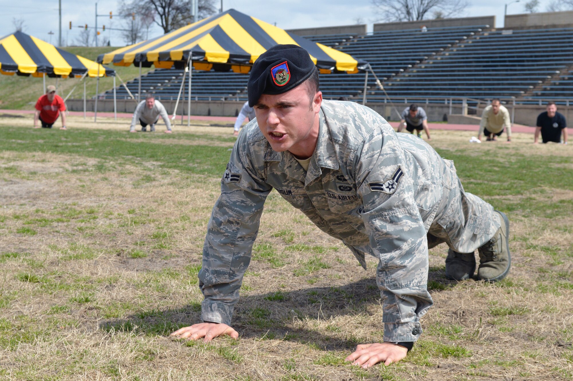 Airman 1st Class Brian Musum, 14th Air Support Operations Squadron, leads Pope Field Tactical Air Control Party airmen during a memorial push up ceremony after a 24-hour run at the Hedrick Stadium track during the third annual worldwide TACP 24-hour Run Challenge fundraising event on March 28. The event is held to honor and raise funds for fallen TACP brothers in arms and their families. TACP airmen from the 18th Air Support Operations Group, 14th Air Support Operations Squadron, 682nd Air Support Operations Squadron and the 18th Weather Squadron accumulated over 2,500 miles during this year’s event at Pope. (U.S. Air Force photo/Marvin Krause)