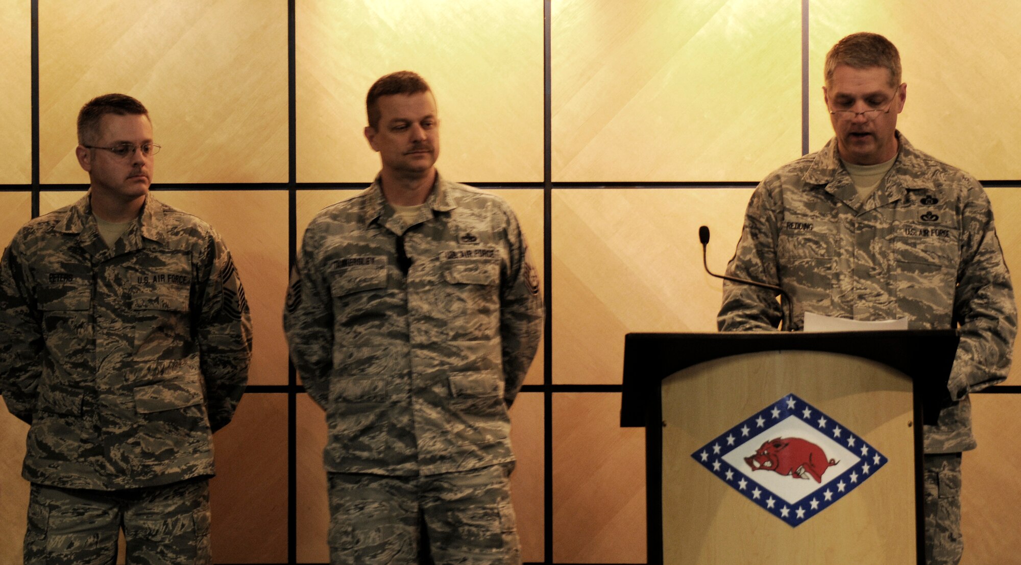 Chief Master Sgt. Ron Redding reads the Chiefs Creed during a promotion ceremony for Chief Master Sgt. Kenneth “Dee” Tankersley, middle, as Chief Master Sgt. Bryan Peters looks on at the 188th Fighter Wing headquarters auditorium March 6, 2014. (U.S. Air National Guard photo by Tech. Sgt. Josh Lewis/released)