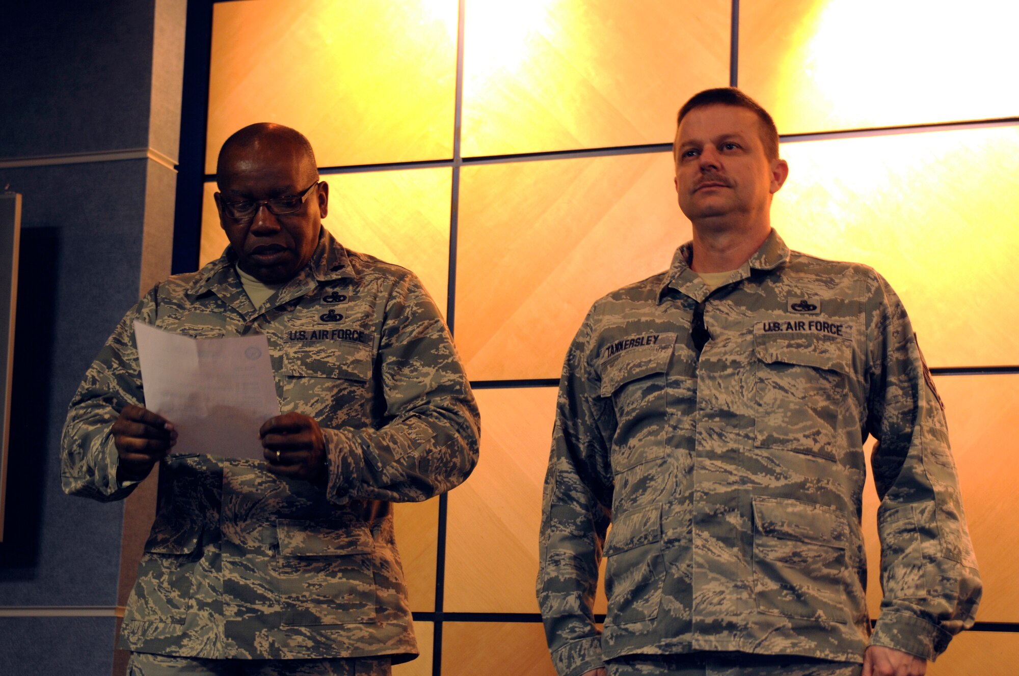Lt. Col. Anderson Neal, 188th Maintenance Group commander, left, reads a promotion order for Chief Master Sgt. Kenneth “Dee” Tankersley at the 188th Fighter Wing headquarters auditorium March 6, 2014. Tankersley became the 188th’s newest chief during the ceremony. (U.S. Air National Guard photo by Tech. Sgt. Josh Lewis/released)