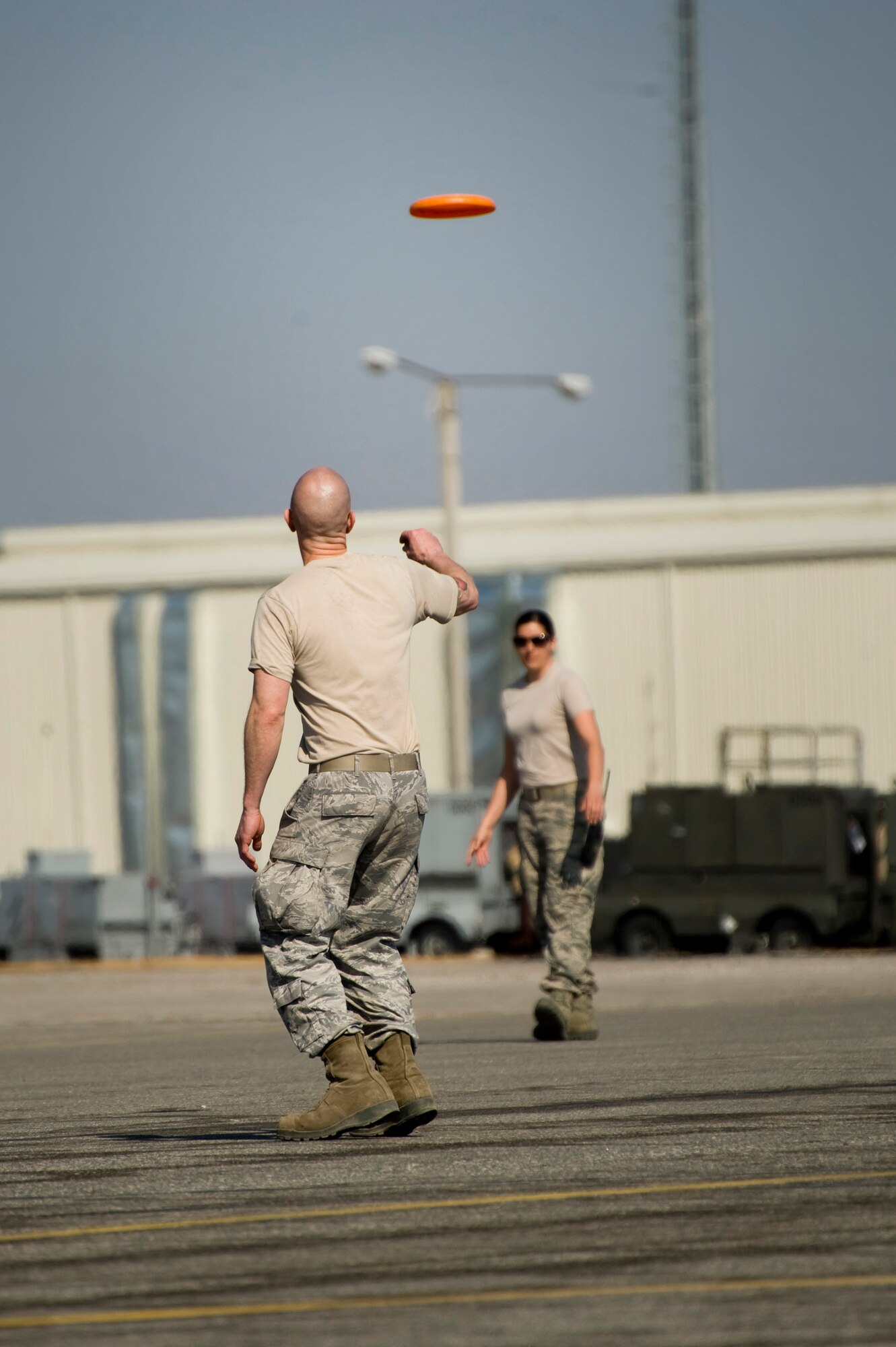Airmen from the 376th Expeditionary Logistics Readiness Squadron Airmen play Frisbee on the grid yard at Transit Center at Manas, Krygyzstan, March 28, 2014.  The Airmen took advantage of some down time on a spring day while awaiting a scheduled cargo load for a C-17 Globemaster III. (U.S. Air Force photo/Lt Col Max Despain)