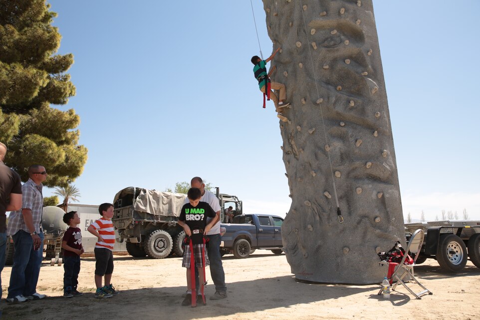Families of 3rd Battalion, 4th Marines, 7th Marine Regiment, participate in a rock-climbing wall event during the unit’s final family day hosted at Desert Winds Golf Course, March 21, 2014. The unit's family day consisted of several events for both the children and adults of the family.