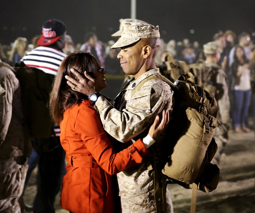 1st Sgt. Jairo Fredonis, weapons company first sergeant, 3rd Battalion, 7th Marine Regiment, embraces his wife, Monique Fredonis, during a homecoming at Del Valle Field, March 22, 2014. The homecoming welcomed Marines and sailors with 3/7, after a seven-month deployment to Afghanistan.


