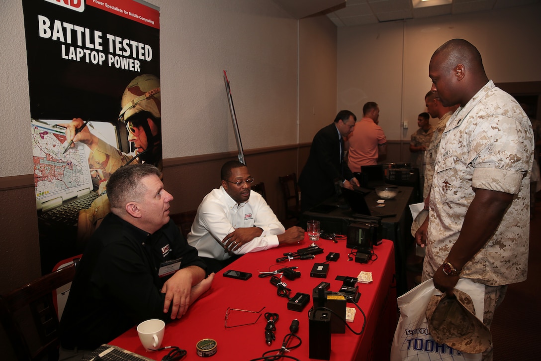 Combat Center Marines speak with Eric Wilson, government military sales manager, and Mark Jansse, federal account manager, Lind Electronics Incorporated, about the different products they offer during the Technology Expo at the Officers' Club, March 25, 2014. The Armed Forces Communication Electronics Association, Twentynine Palms chapter, hosted the event which facilitated dialogue between companies and Marines.


