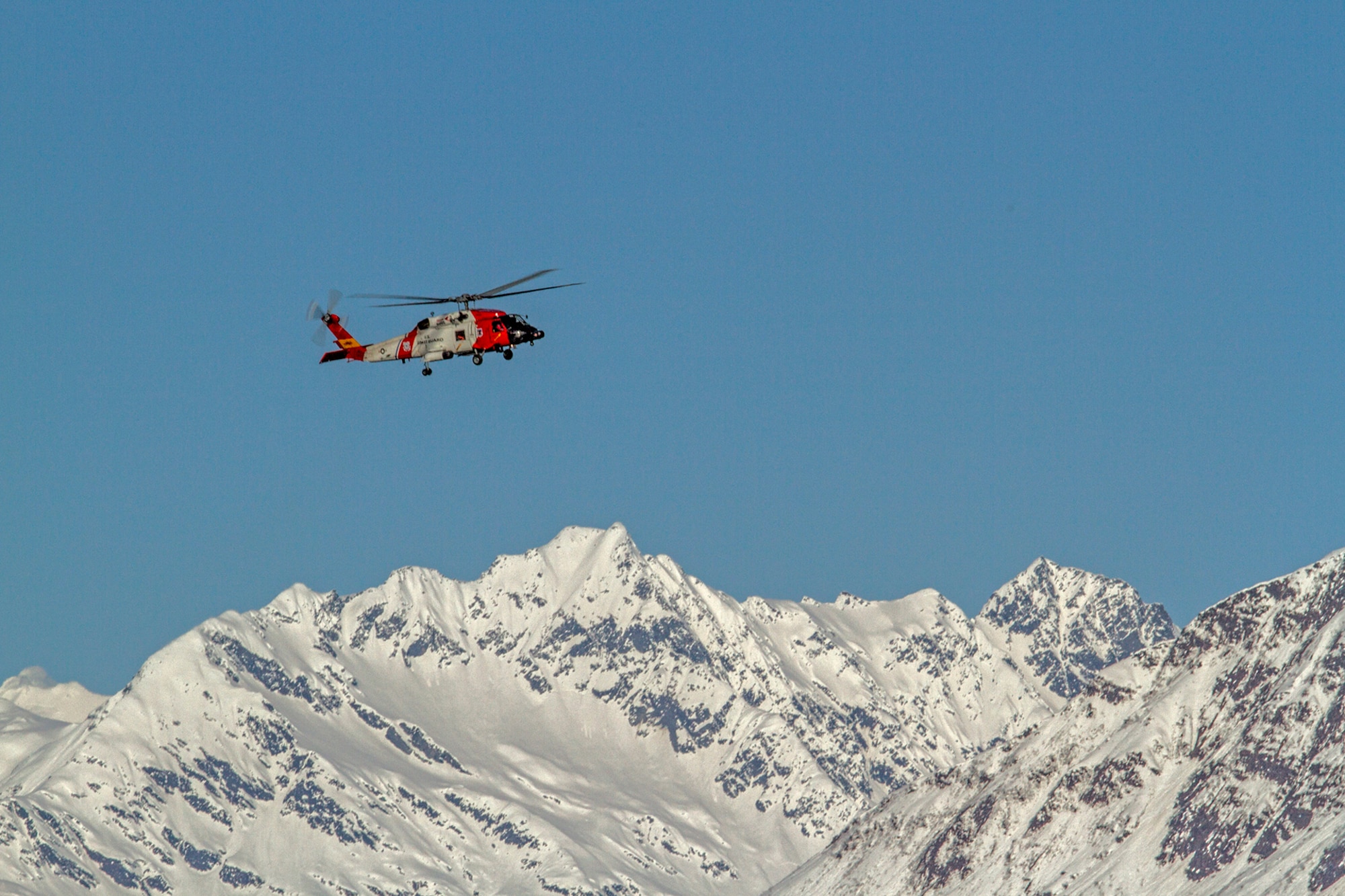 Members of U.S. Coast Guard Air Station Kodiak conduct a search and rescue mission in a HH-60 Jayhawk rescue helicopter during exercise Alaska Shield 14 here, March 29, 2014. Alaska Shield 14 is an exercise that involves state, federal, military, and local agencies, designed to test response and coordination efforts during a disaster and is modeled after the 1964 earthquake and subsequent tsunami that devastated much of South Central Alaska including the city of Valdez. (U.S. Army photo by Sgt. Benjamin John)