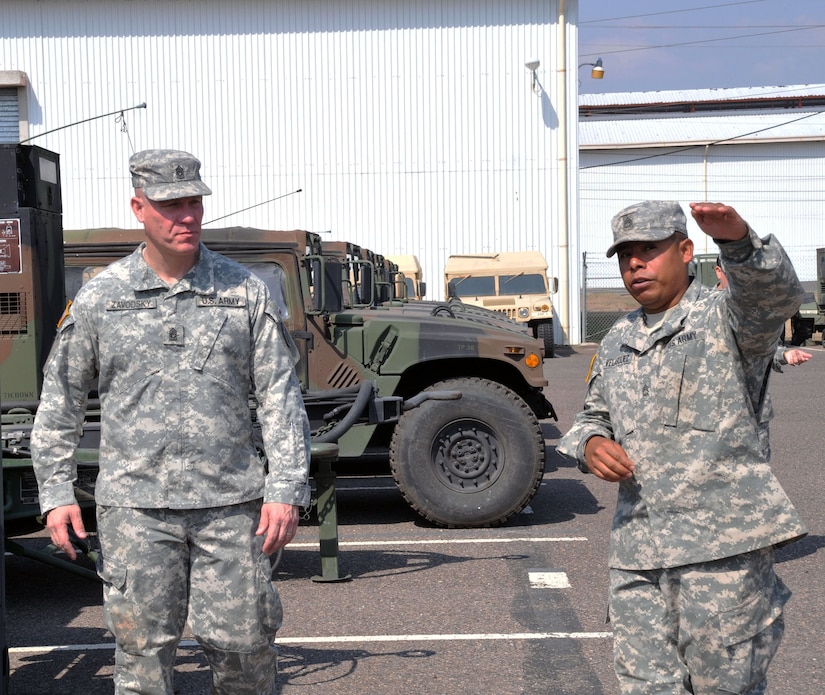 Command Sgt. Maj. Dennis Zavodsky receives a tour of the motor pool form U.S. Army Sgt. 1st Class Selvin Velasquez, Motor Sergeant for Army Forces Battalion, Joint Task Force-Bravo. The U.S. Army South Command Sergeant Major visited Joint Task Force-Bravo 24-27 March, 2014 to meet with senior enlisted leaders and members of Joint Task Force-Bravo's Army Forces Battalion (ARFOR), Medical Element (MEDEL), Joint Security Forces (JSF) and the military working dogs section, 1-228th Aviation Regiment, and 612th Air Base Squadron as well as learn about the missions performed at Soto Cano Air Base, Honduras. (Photo by Ana Fonseca)