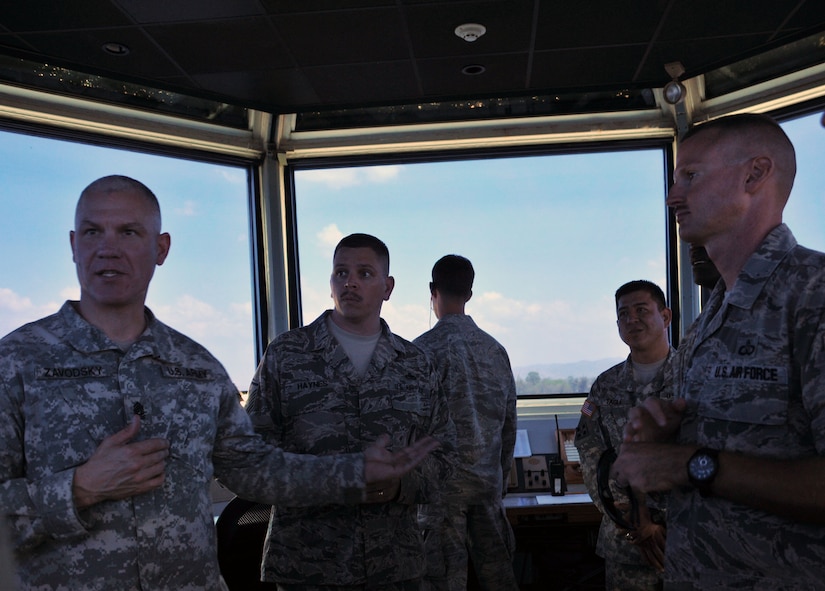 Command Sgt. Maj. Dennis Zavodsky receives a capabilities brief from U.S. Air Force Master Sergeants David Haynes and Richard Babb during a visit to the Air Traffic Control Tower March 24, 2014 at Soto Cano Air Base, Honduras. The U.S. Army South Command Sergeant Major visited Joint Task Force-Bravo 24-27 March, 2014 to meet with senior enlisted leaders and members of Joint Task Force-Bravo's Army Forces Battalion (ARFOR), Medical Element (MEDEL), Joint Security Forces (JSF) and the military working dogs section, 1-228th Aviation Regiment, and 612th Air Base Squadron as well as learn about the missions performed at Soto Cano Air Base, Honduras. (Photo by Ana Fonseca)