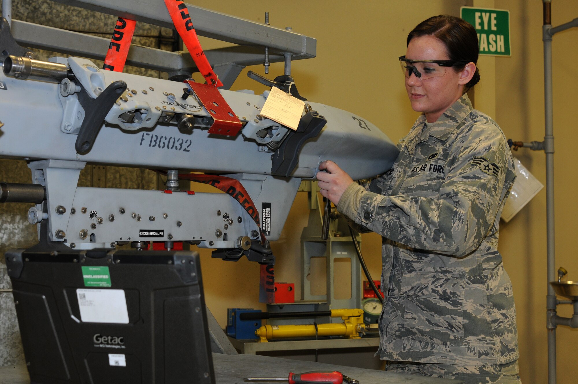 Senior Airman Aimee Adams with the 188th Aircraft Maintenance Squadron works on the triple ejector rack (TER-9A) at Ebbing Air National Guard Base, Fort Smith, Ark., March 2, 2014. Adams was named The Flying Razorback Spotlight for April 2014. The TER-9A is designed to carry three 500-pound bombs. (U.S. Air National Guard photo by Airman 1st Class Cody Martin/released)