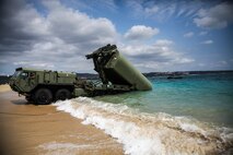 A bay making up the Improved Ribbon Bridge is launched out to sea by the Marine Corps Bridge Pallet system Feb. 7 at Camp Schwab new equipment training. The five days of training enabled the Marines to build on their previous knowledge of bridges and learn the fundamentals of the new IRB. The Marines participating are with 9th Engineer Support Battalion, 3rd Marine Logistics Group